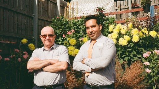 Ray and Azaz, standing in front of their award winning garden at South Tottenham station
